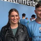 Manchester City fans celebrate outside the Etihad