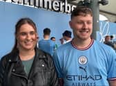 Manchester City fans celebrate outside the Etihad