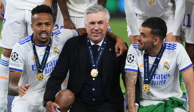 Carlo Ancelotti, Head Coach of Real Madrid interacts with Eder Militao and Dani Ceballos of Real Madrid following their sides victory in the UEFA Champions League final match between Liverpool FC and Real Madrid at Stade de France on May 28, 2022 in Paris, France. (Photo by Shaun Botterill/Getty Images)