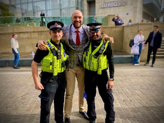 World heavyweight boxing champion Tyson Fury stopped to pose for pictures with GMP officers in Manchester Credit: GMP/SWNS