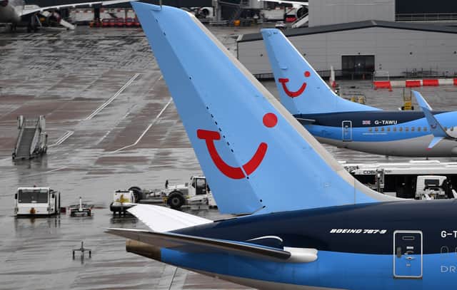 A pilot helped load luggage onto a plane at Manchester Airport.