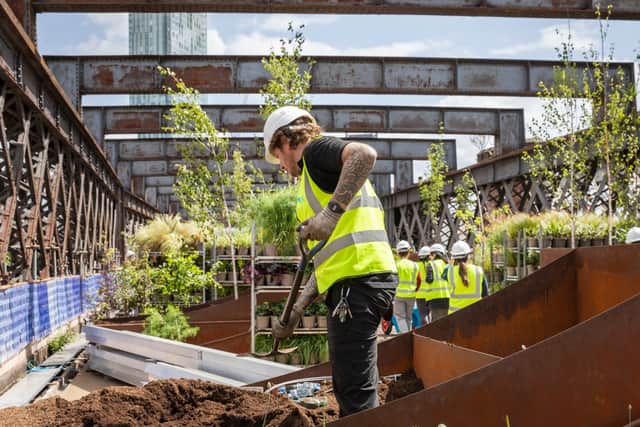 National Trust gardeners working on Castlefield Viaduct. Photo: Annapurna Mellor/National Trust Images