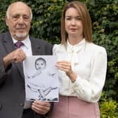 Nuclear test veteran John Morris and his granddaughter Laura Morris holding a picture of John’s son Stephen. Photo: Phil Harris