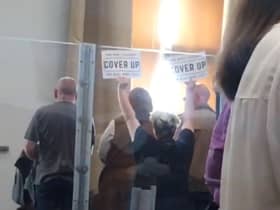 Members of the public waved signs that said cover up’ at a meeting Oldham Council convened to discuss the findings of the CSE report