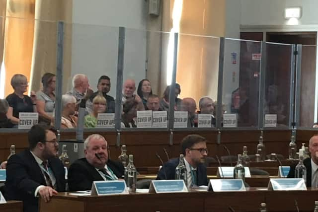 Signs in the public gallery alleging a cover-up at the meeting Oldham Council convened to discuss the CSE report