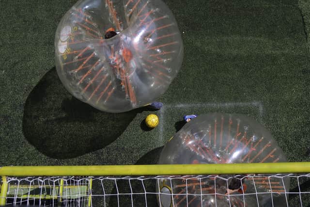 You can enjoy a five-a-side game of bubble football (Photo by RAUL ARBOLEDA/AFP via Getty Images)