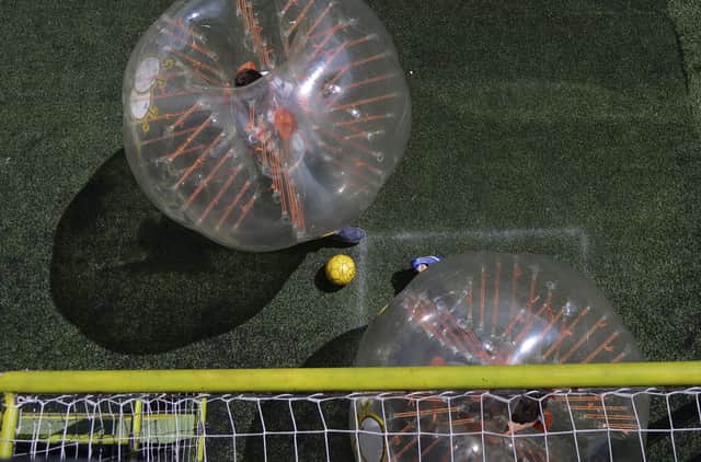 You can enjoy a five-a-side game of bubble football (Photo by RAUL ARBOLEDA/AFP via Getty Images)