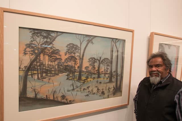 Goreng Noongar Elder Ezzard Flowers with one of the Carrolup artworks done by Barry Loo. Photo: Brad Coleman/John Curtin Gallery