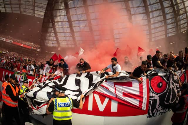 Rayo fans cling onto the banner in question while red smoke can be seen behind. Credit: Getty.