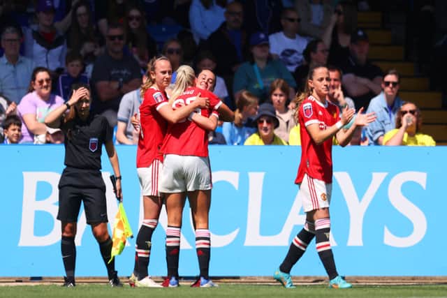 Ella Toone of Manchester United celebrates with teammates after scoring their team's second goal during the Barclays FA Women's Super League match between Chelsea Women and Manchester United Women at Kingsmeadow on May 08, 2022 in Kingston upon Thames, England. (Photo by Catherine Ivill/Getty Images)