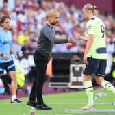 Pep Guardiola, Manager of Manchester City interacts with Erling Haaland after the striker was substituted in Sunday’s 2-0 win at West Ham United (Photo by Mike Hewitt/Getty Images)