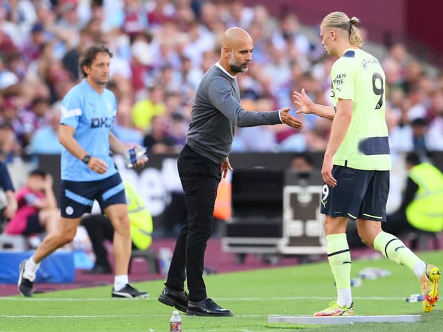 Pep Guardiola, Manager of Manchester City interacts with Erling Haaland after the striker was substituted in Sunday’s 2-0 win at West Ham United (Photo by Mike Hewitt/Getty Images)