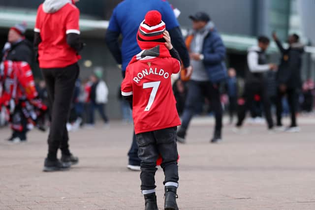 A young fan wearing a “Ronaldo” Man Utd shirt Credit: Getty