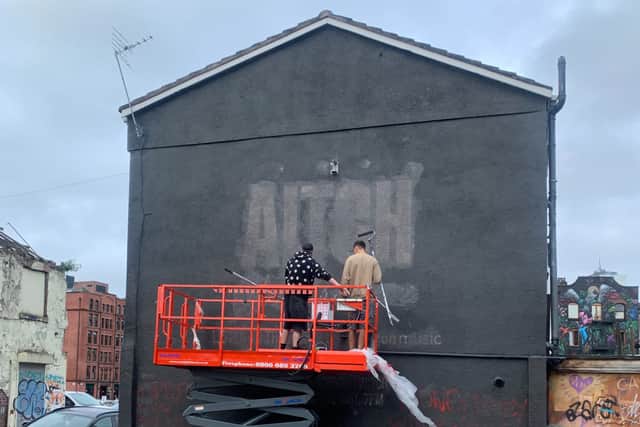 Workers removing the advert for Aitch’s album on Port Street. Photo: Coun Pat Karney