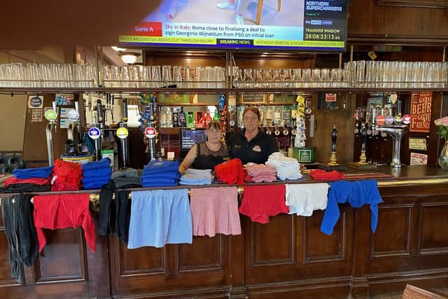 Joseph Holt Danielle and Blane McIntosh at the Bricklayer’s Arms in Salford with donated school uniforms Credit: LDRS