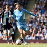 Newcastle United’s Miguel Almiron vies with Manchester City star Jack Grealish  (Photo by PAUL ELLIS/AFP via Getty Images)
