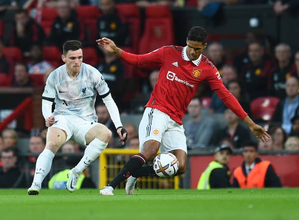 Andy Robertson challenges Manchester United star Raphael Varane (Photo by Andrew Powell/Liverpool FC via Getty Images)