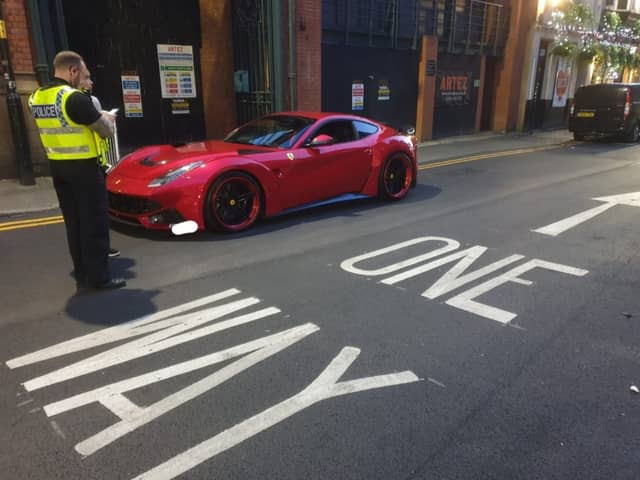 Greater Manchester Police dealing with the Ferrari in the city centre