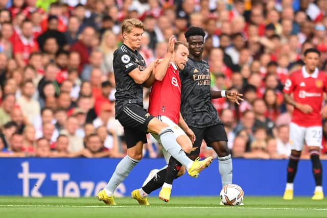 Christian Eriksen of Manchester United is fouled by Martin Oedegaard of Arsenal during the Premier League match  (Photo by Michael Regan/Getty Images)