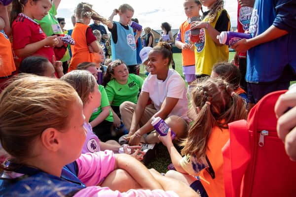 Manchester United and England forward Nikita Parris visits Weetabix Wildcats under 12s girls football players Credit: SWNS