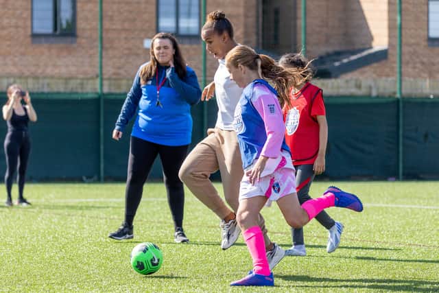 Manchester United and England forward Nikita Parris visits Weetabix Wildcats under 12s girls football players Credit: SWNS