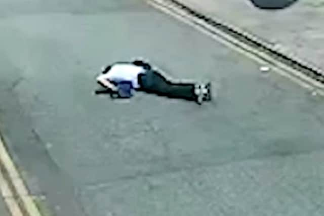 CCTV showed the Sikh priest out cold on Tib Street in Manchester Credit: GMP