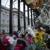 Hundreds of bouquets of flowers have been placed at the gates of Buckingham Palace. (Credit: Getty Images)