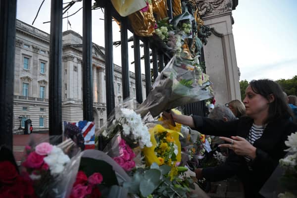 Hundreds of bouquets of flowers have been placed at the gates of Buckingham Palace. (Credit: Getty Images)