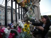 Hundreds of bouquets of flowers have been placed at the gates of Buckingham Palace. (Credit: Getty Images)