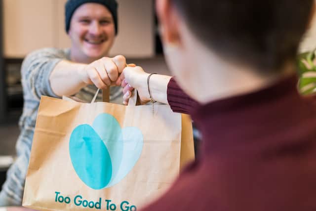 Man picks up his Magic Bag of unwanted food. Credit: Too Good to Go