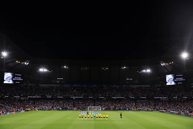 Both sides stood for a moment of silence ahead of the game. Credit: Getty.