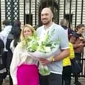 Tyson Fury laying flowers down outside Buckingham Palace with Paris Credit: Eileen Brown / SWNS