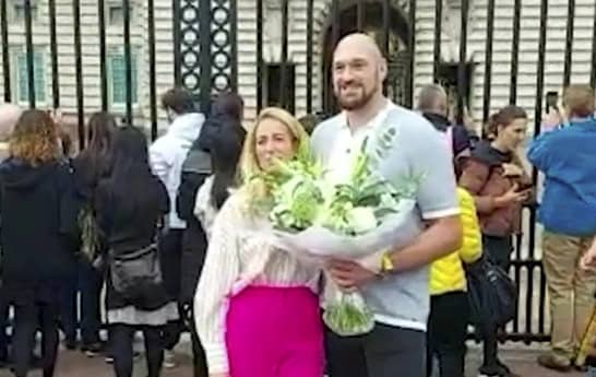 Tyson Fury laying flowers down outside Buckingham Palace with Paris Credit: Eileen Brown / SWNS