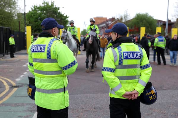 Police outside Old Trafford last season Credit: Getty