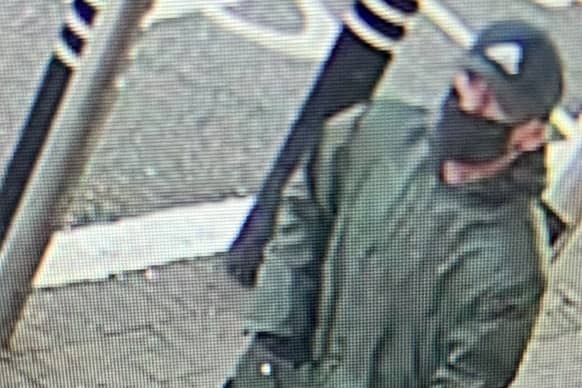 Police are searching for this man after nearly £30k was taken in a cash-in-transit robbery at Asda Hulme Credit: GMP