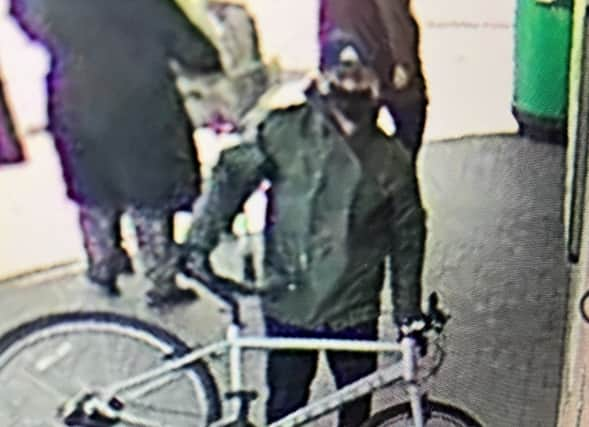 Police are searching for this man after nearly £30k was taken in a cash-in-transit robbery at Asda Hulme Credit: GMP