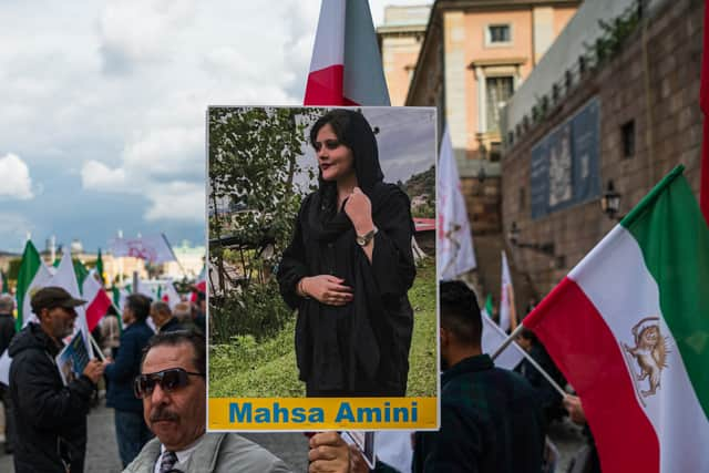 Protestors in Sweden holding up a picture of Mahsa Amini. Photo: Jonathan Nackstrand/AFP via Getty Images