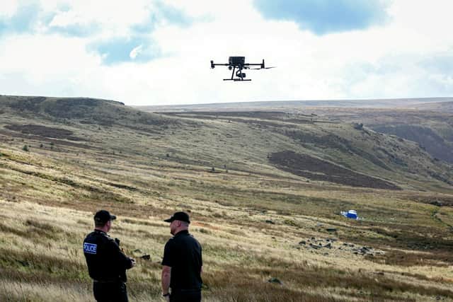 Police use a drone as they continue to investigate on Saddleworth Moor Credit: Matt Lofthouse / SWNS