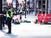 Police officers at the scene after three people have been taken to hospital following reports of stabbings at Bishopsgate in London. Picture date: Thursday October 6, 2022.