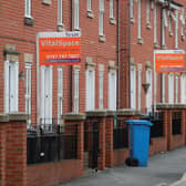 Boards advertising houses for rent in Manchester. Photo: Getty Images