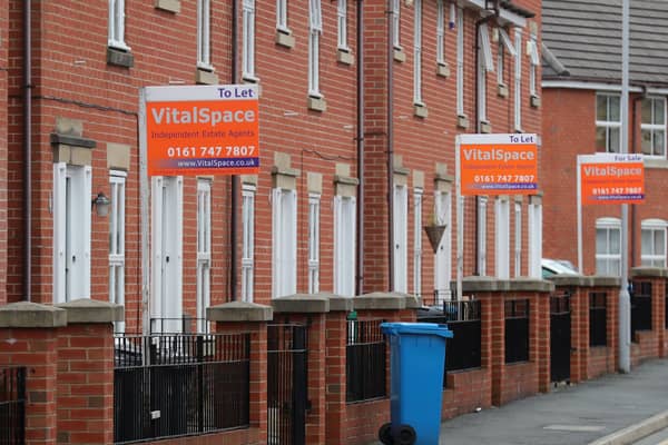 Boards advertising houses for rent in Manchester. Photo: Getty Images