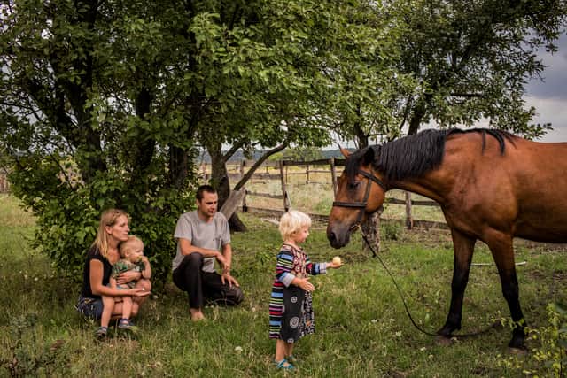 Olga and Nikolay Grinik live 50 meters away from a Ukrainian frontline military position in old Avdeevka, Donetsk Oblast, and their children were born during the war. Credit: Anastasia Taylor-Lind 