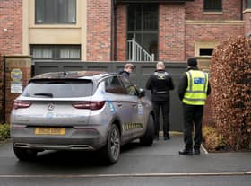 Police officers standing outside Mason Greenwood’s house in February 2022.