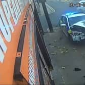 The wrecked police car after it collided with another vehicle and ploughed into a railing in Oldham. Photo: SWNS