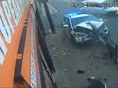 The wrecked police car after it collided with another vehicle and ploughed into a railing in Oldham. Photo: SWNS
