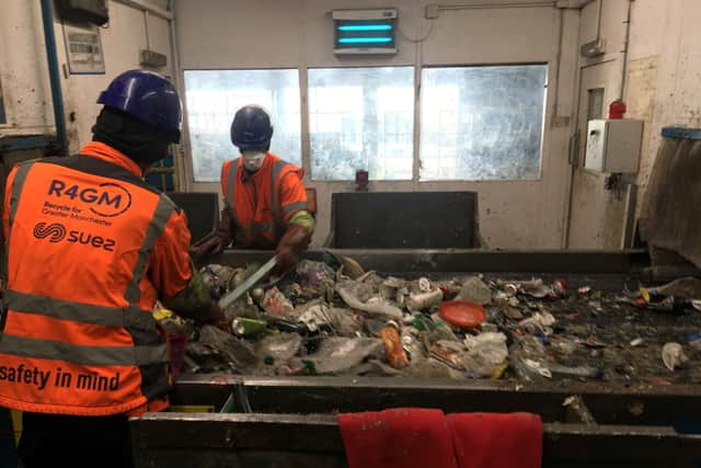 Workers on a conveyor belt at the recycling facility. Photo: LDRS