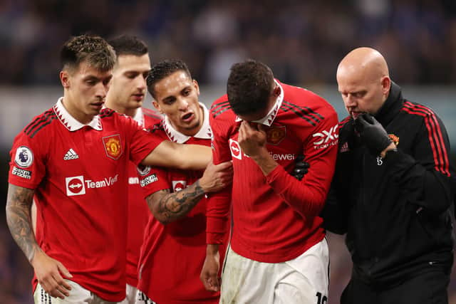 Varane was visibly upset when he was forced off against Chelsea. Credit: Getty.