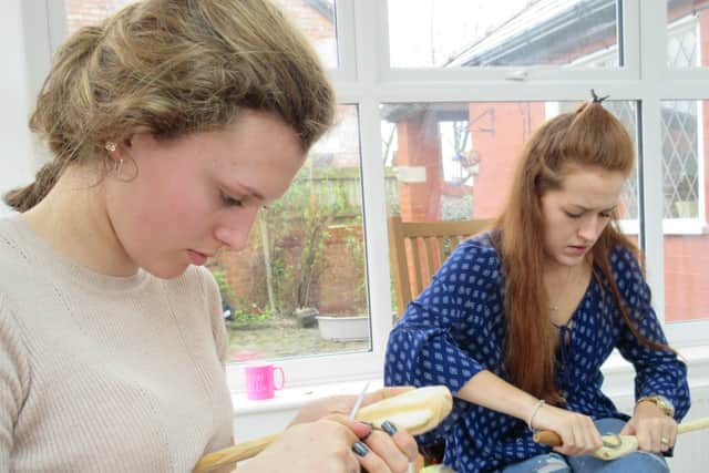 Spoon carvers creating their home-made kitchenware