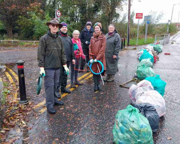 Litter pickers with bags of rubbish collected from the area near Manchester Airport