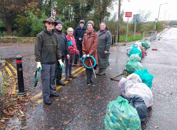 Litter pickers with bags of rubbish collected from the area near Manchester Airport